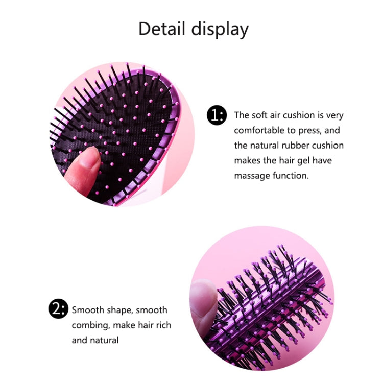 Round air-cushion hair brush showing black bristle pad with pink-tipped pins.