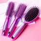 Three purple hair brushes with black bristles and silver handles, air-cushion style.