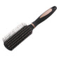 Black oval hair massage brush with silver pins across the full pad and curved handle.
