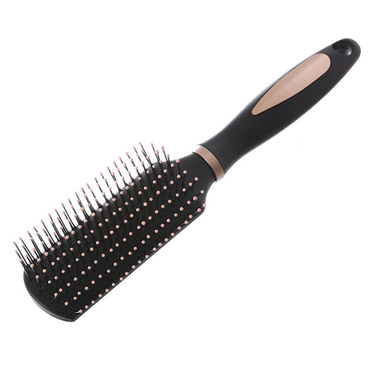 Black oval hair massage brush with silver pins across the full pad and curved handle.