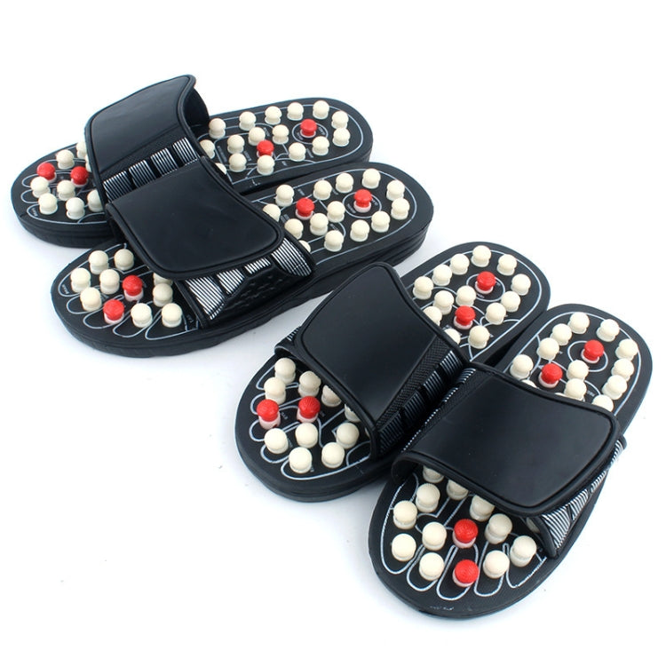 Pair of black massage slide sandals with acupoint studs in white and red