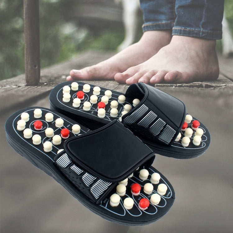 Massage flip-flops with raised acupoint nubs; worn hand holding the sandal