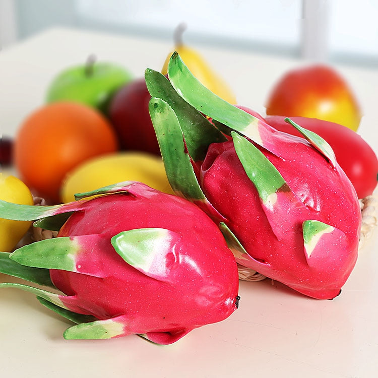 Red dragon fruit ornament set with green leaves, arranged in a group for display