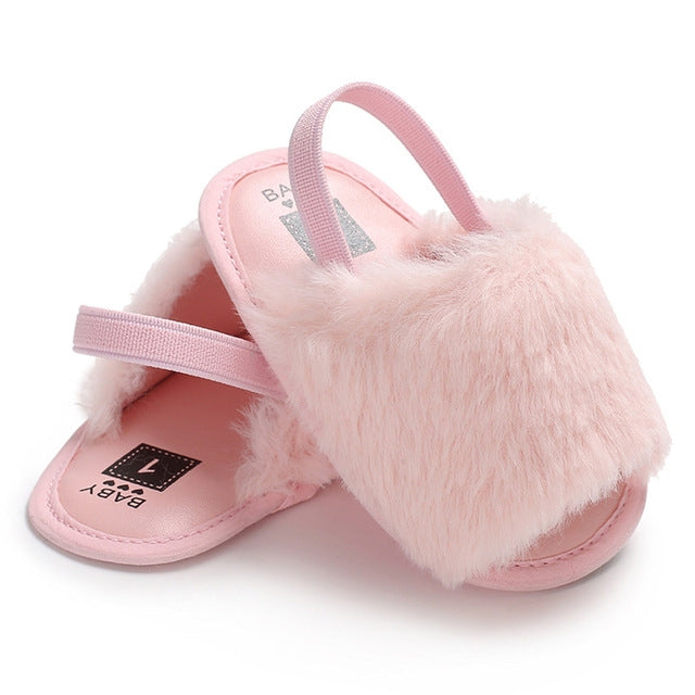 Pink faux-fur soft-sole crib sandals with adjustable strap, open toe