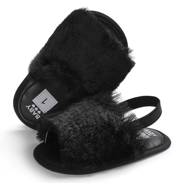 Black faux-fur soft-sole baby sandals with adjustable strap and open toe
