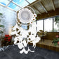 White dream catcher with circular web, layered feathers, and daisy flowers