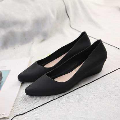 Black square-toe slip-on flats with low wedge heel, shown as a pair