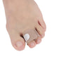 Toe separator splint with beige strap and circular pad on a toe, hook-and-loop style