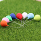 8 mini balloon decorations set on green grass with mixed-color balloon heads