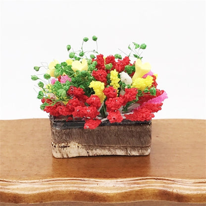 Mini clay flower arrangement in rectangular planter, red and yellow blooms with green stems