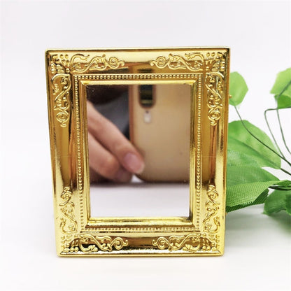 Mini wall mirror toy with ornate gold square frame and reflective glass center