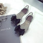Transparent jellyfish-mouth flat shoes with dark bow ties and clear upper straps