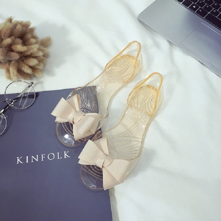 Transparent jelly flat shoes with cream bow and clear upper, open toe