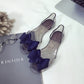 Clear jellyfish-mouth flat shoes with dark bow ties and pointed toe design