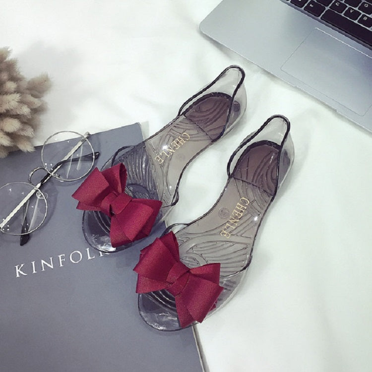 Transparent jelly flat shoes with dark red bow and clear upper, open toe