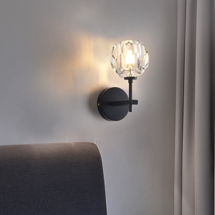 Black crystal wall sconce with round backplate and faceted glass shade