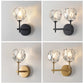 Wall sconce set showing black and gold crystal shades with round backplates