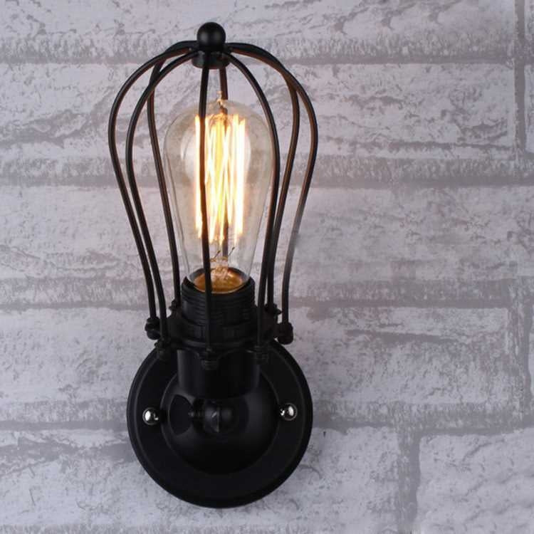 Wall lantern light with black metal cage, clear glass tube, glowing Edison-style filament