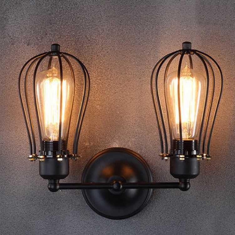Double-head wall lantern light with black bar mount, two clear glass cages and Edison bulbs