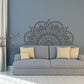 White mandala wall sticker with ornate circular design above sofa