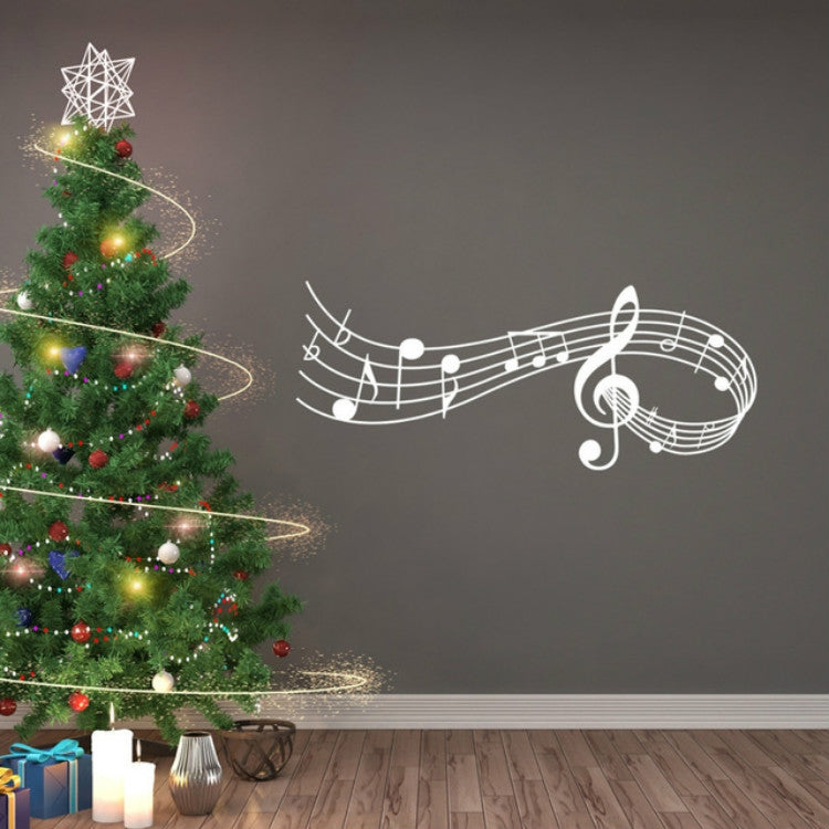 White music note wall decal with treble clef and staff lines on a dark wall