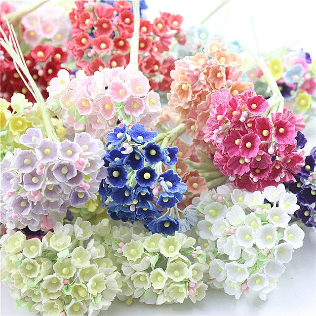 Colorful flocked plum blossom stems with small flowers and green centers