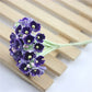 Purple mini faux flocked plum blossom flower on a decorative branch stem
