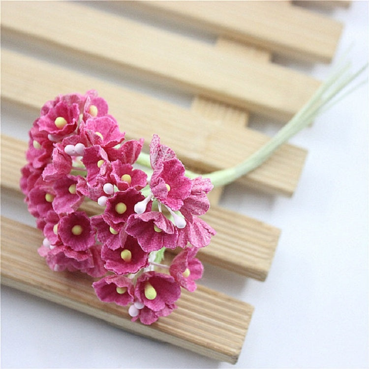 Pink mini faux flocked plum blossom flower on a decorative branch stem