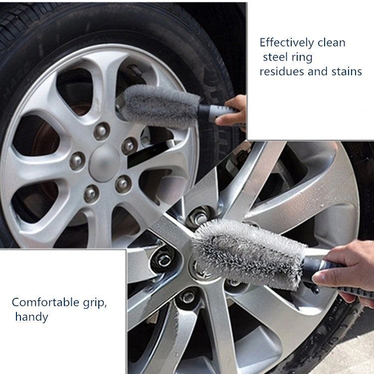 Car wheel cleaning brush scrubbing a silver alloy wheel rim