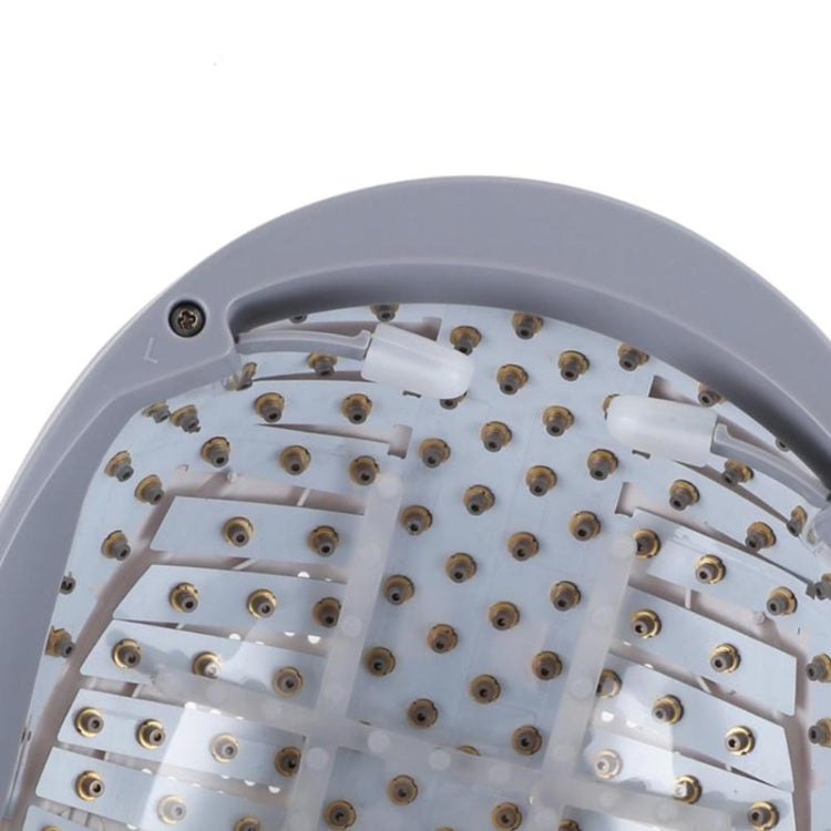 Light gray helmet interior with rows of metal electrodes on white tray