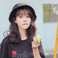 Black cotton fisherman bucket hat on head with wide brim