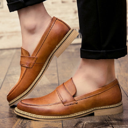 Brown leather slip-on loafers with pointed toe and cushioned collar, rubber sole