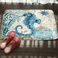 Sea creature and starfish printed flannel bath mat with non-slip backing, blue and cream