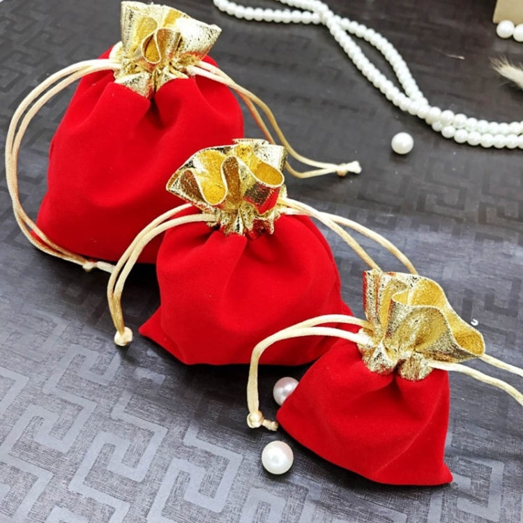 Red velvet drawstring jewelry pouches with gold bows and beige cords