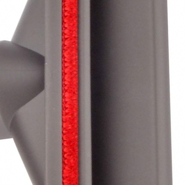 Close-up of red bristle strip on gray vacuum brush head