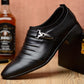 Men's black pointed-toe oxford shoes with decorative buckle strap and low block heel.