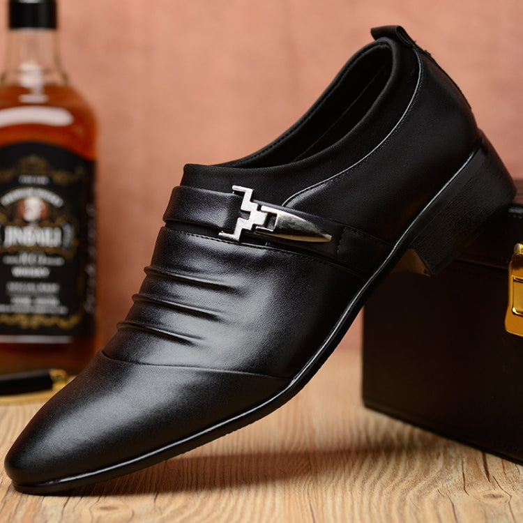 Men's black pointed-toe oxford shoes with decorative buckle strap and low block heel.
