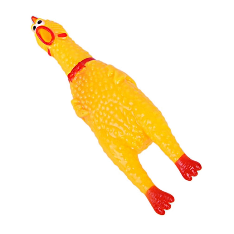 Yellow rubber chicken squeaky pet toy with red beak and feet, lying down.