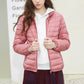 Pink hooded puffer jacket with white drawstring hood and zip front