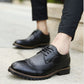 Dark blue lace-up brogue oxford shoes with wingtip perforations and chunky outsole