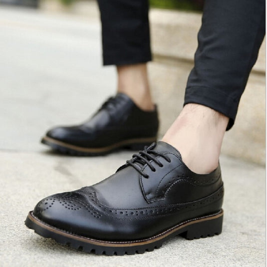Dark blue lace-up brogue oxford shoes with wingtip perforations and chunky outsole