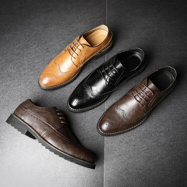 Set of three lace-up brogue oxford shoes in tan, black, and brown on display