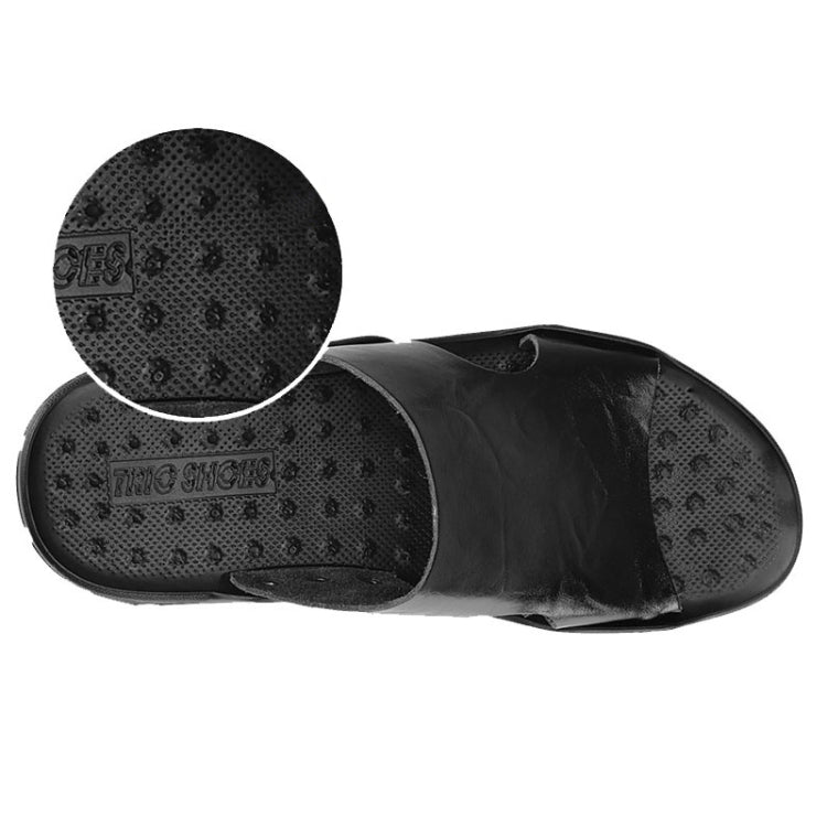 Men's black slide sandals with textured outsole, side buckle strap, and inset tread