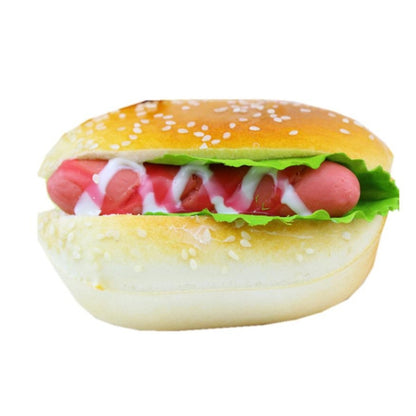 Hamburger squishy toy with yellow bun, green lettuce, and red filling