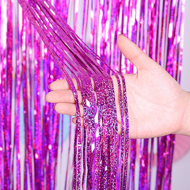 Magenta purple holographic foil tinsel curtain with glitter strands, held up.