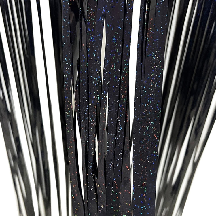 Dark foil tinsel curtain with glitter speckled vertical strands, held up.