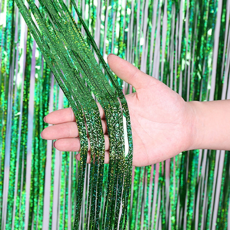 Laser rain tinsel foil curtain, green glitter strands tied at top, held in hand