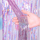 Laser rain tinsel foil curtain, light purple silver glitter strands tied at top, held in hand