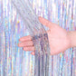 Silver holographic laser foil fringe curtain, hand holding glittering vertical strands