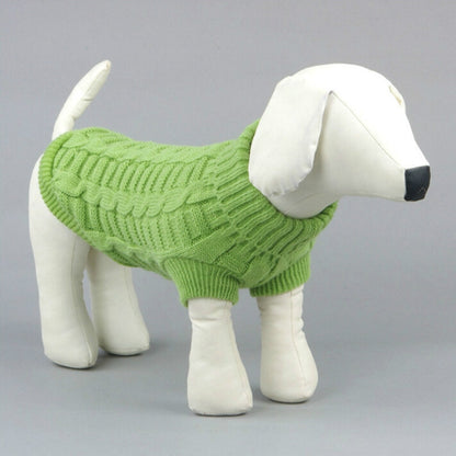 Green knitted dog sweater with ribbed neckline and hem, cable knit pattern.